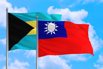 Taiwan and Bahamas national flag waving in the windy deep blue sky. Diplomacy and international relations concept.
