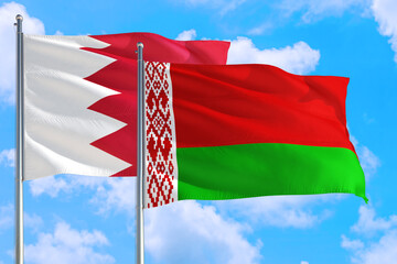 Belarus and Bahrain national flag waving in the windy deep blue sky. Diplomacy and international relations concept.