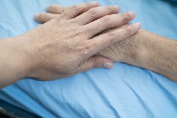 Holding hands Asian senior or elderly old lady woman patient with love, care, encourage and empathy at nursing hospital ward, healthy strong medical concept