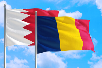 Chad and Bahrain national flag waving in the windy deep blue sky. Diplomacy and international relations concept.