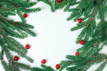 The backdrop for Christmas. Green spruce branches, small red garland balls.
