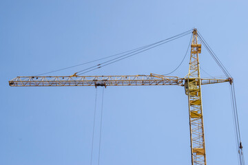 yellow crane and blue clear sky on construction site