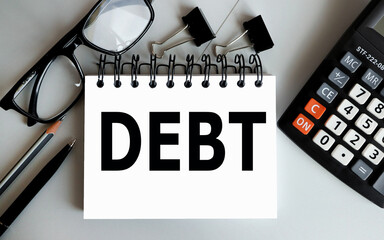 DEBT, text on white paper ON GRAY BACKGROUND