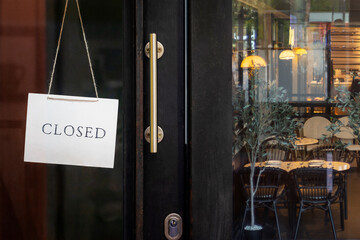 closed sign hanging outside a restaurant, store, office or other