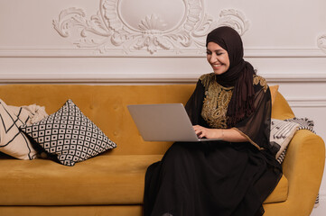 arab business woman working on laptop from home