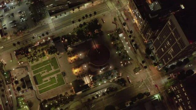 Pershing square in Downtown Los Angeles, California at Night with lit up glowing city street lights, Aerial Birds Eye Overhead Top Down View
