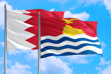 Kiribati and Bahrain national flag waving in the windy deep blue sky. Diplomacy and international relations concept.