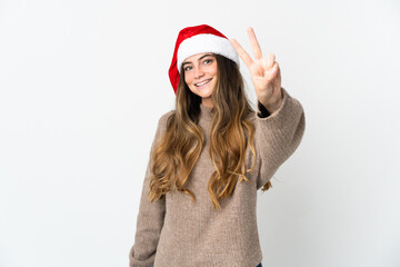 Caucasian girl with christmas hat isolated on white background smiling and showing victory sign