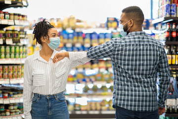 Lady In Mask Bumping Elbows With Guy In Grocery Store