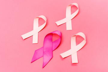 High angle view of ribbons of breast cancer awareness on pink background