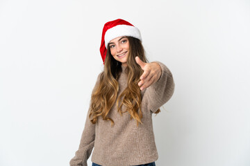 Caucasian girl with christmas hat isolated on white background shaking hands for closing a good deal