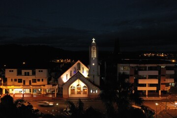 Fototapeta premium Puyo, Ecuador, 20-7-2020: Aerial view of a small church at night