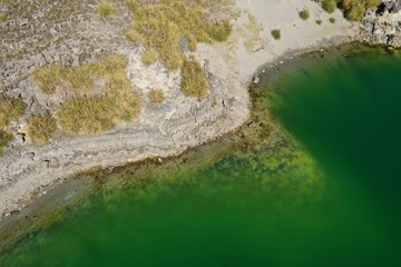 Aerial view over a lake with chemical dark green water