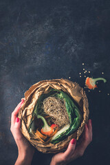 Garbage sorting. Organic food waste from vegetable ready for recycling and to compost  in woman...