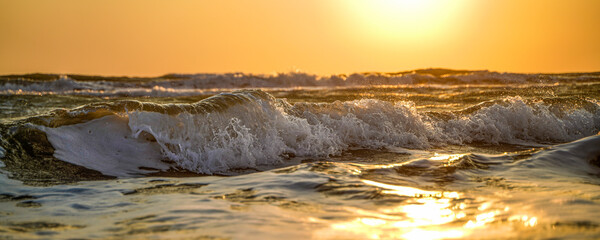 Waves crashing at sunset