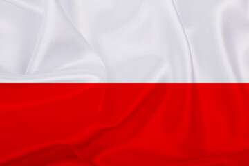 Polish flag - fabric texture flag of Poland. Flag of Poland waving in the wind.