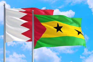 Sao Tome And Principe and Bahrain national flag waving in the windy deep blue sky. Diplomacy and...