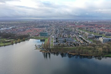 Fototapeta premium Aerial view over a small lake found in a large city in Europe