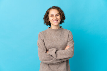Young English woman isolated on blue background keeping the arms crossed in frontal position