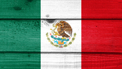 Mexico flag painted on old wood plank background. Brushed natural light knotted wooden board texture. Wooden texture background flag of Mexico.
