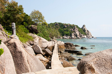 a walkway between rocks and sea 