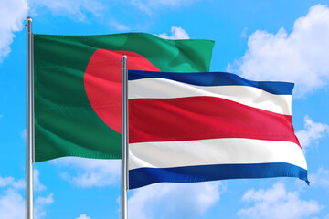 Costa Rica and Bangladesh national flag waving in the windy deep blue sky. Diplomacy and international relations concept.