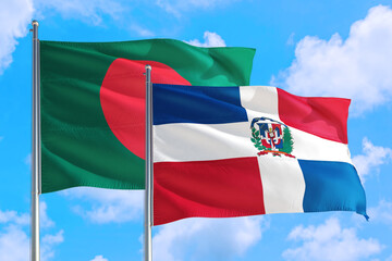 Dominican Republic and Bangladesh national flag waving in the windy deep blue sky. Diplomacy and international relations concept.