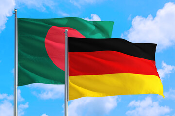 Germany and Bangladesh national flag waving in the windy deep blue sky. Diplomacy and international relations concept.