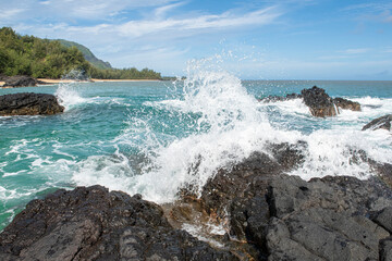 Fototapeta na wymiar Kauai wave crashing against lava rock