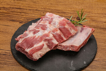 Raw pork ribs served rosemary