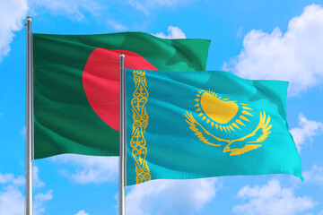 Kazakhstan and Bangladesh national flag waving in the windy deep blue sky. Diplomacy and international relations concept.