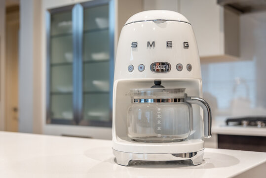 Calgary, Alberta - November 10, 2020: SMEG coffee maker in a modern kitchen.
