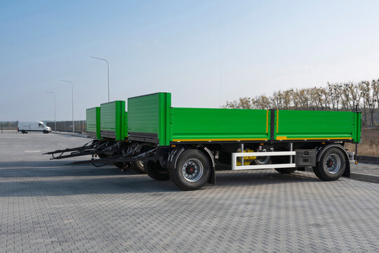 Truck trailers are parked. Sale and rental of trailers, agriculture.