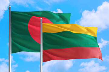 Lithuania and Bangladesh national flag waving in the windy deep blue sky. Diplomacy and international relations concept.