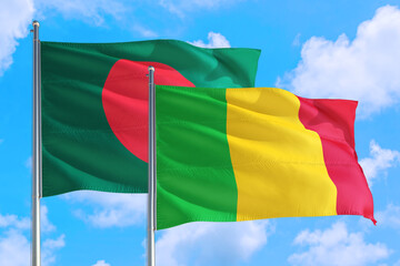 Mali and Bangladesh national flag waving in the windy deep blue sky. Diplomacy and international relations concept.