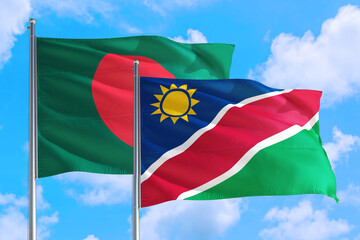 Namibia and Bangladesh national flag waving in the windy deep blue sky. Diplomacy and international relations concept.