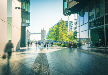 business people, modern buildings and Tower Bridge, London, UK