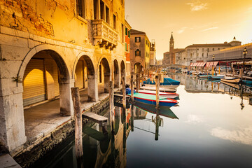 Romantic cityscape of Ghioggia - near Venice - with canals, buidings, bridges and canals in sunset sunlight. Bridge di Vico