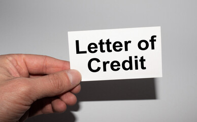 Message on the card LETTER OF CREDIT, in hands of businessman.