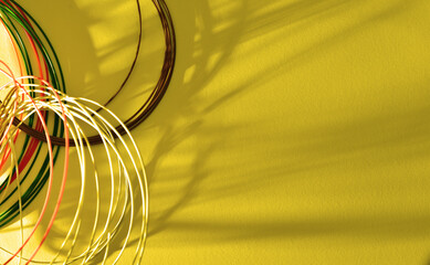 Abstract yellow background with skeins of colored fishing line.