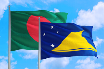 Tokelau and Bangladesh national flag waving in the windy deep blue sky. Diplomacy and international relations concept.