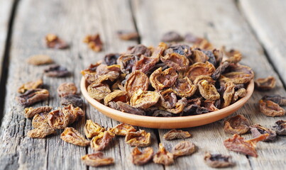 Wooden background with dried apricots.Home preparation of dried fruits.