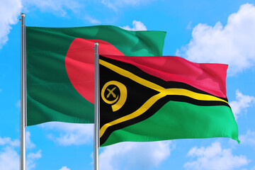 Vanuatu and Bangladesh national flag waving in the windy deep blue sky. Diplomacy and international relations concept.