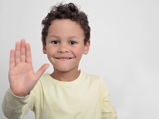 boy with hand showing stop gesture on white background stock photo 