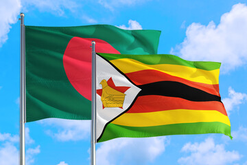 Zimbabwe and Bangladesh national flag waving in the windy deep blue sky. Diplomacy and international relations concept.