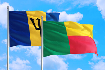 Benin and Barbados national flag waving in the windy deep blue sky. Diplomacy and international relations concept.
