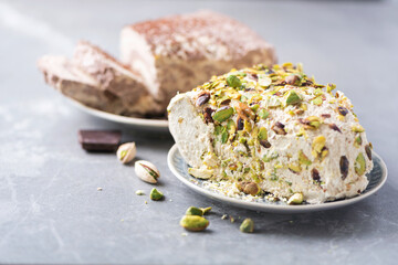 Sesame chocolate halva and halva with pistachios on grey background. Top view. Copy space. Traditional middle eastern sweets. Jewish, turkish, arabic national dessert. Turkish delight