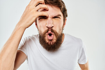 Obraz premium emotional man with a beard gesturing with his hands close-up studio aggression