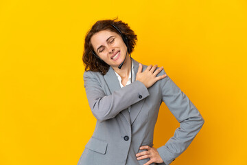 Young English woman isolated on yellow background suffering from pain in shoulder for having made an effort