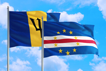 Cape Verde and Barbados national flag waving in the windy deep blue sky. Diplomacy and international relations concept.